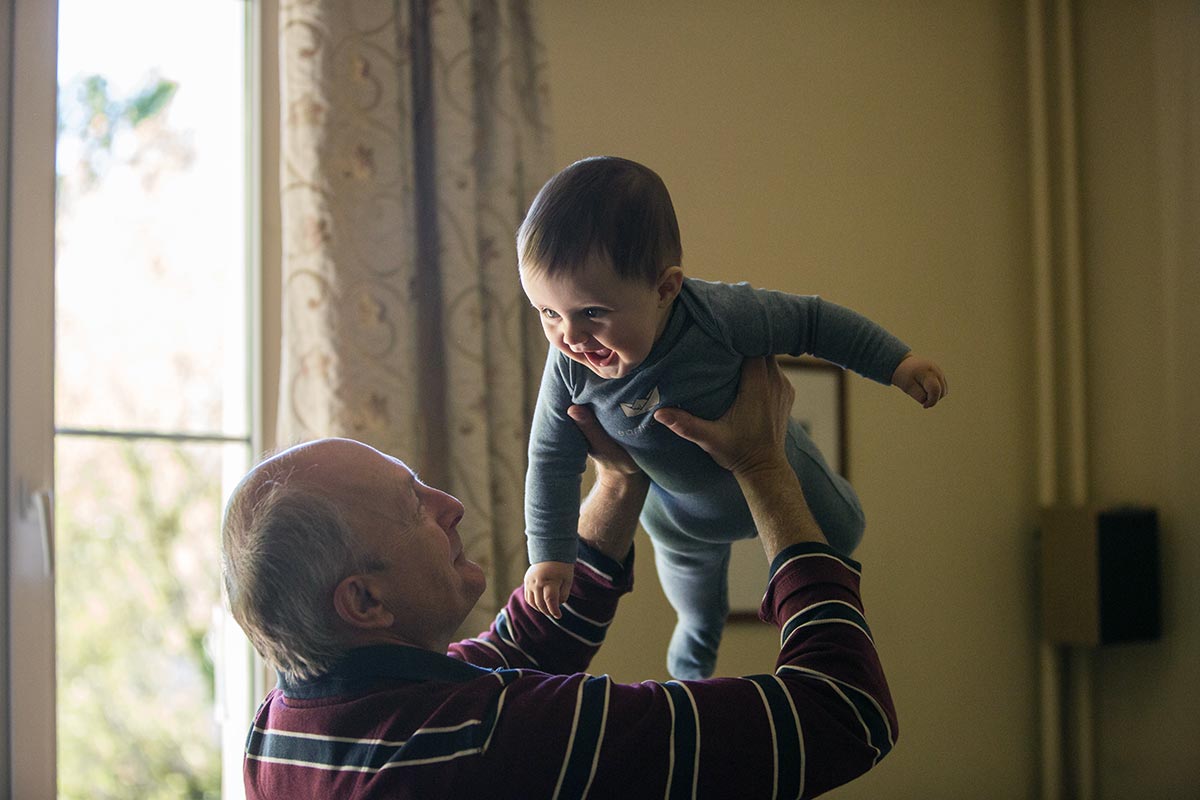 grandfather baby holding