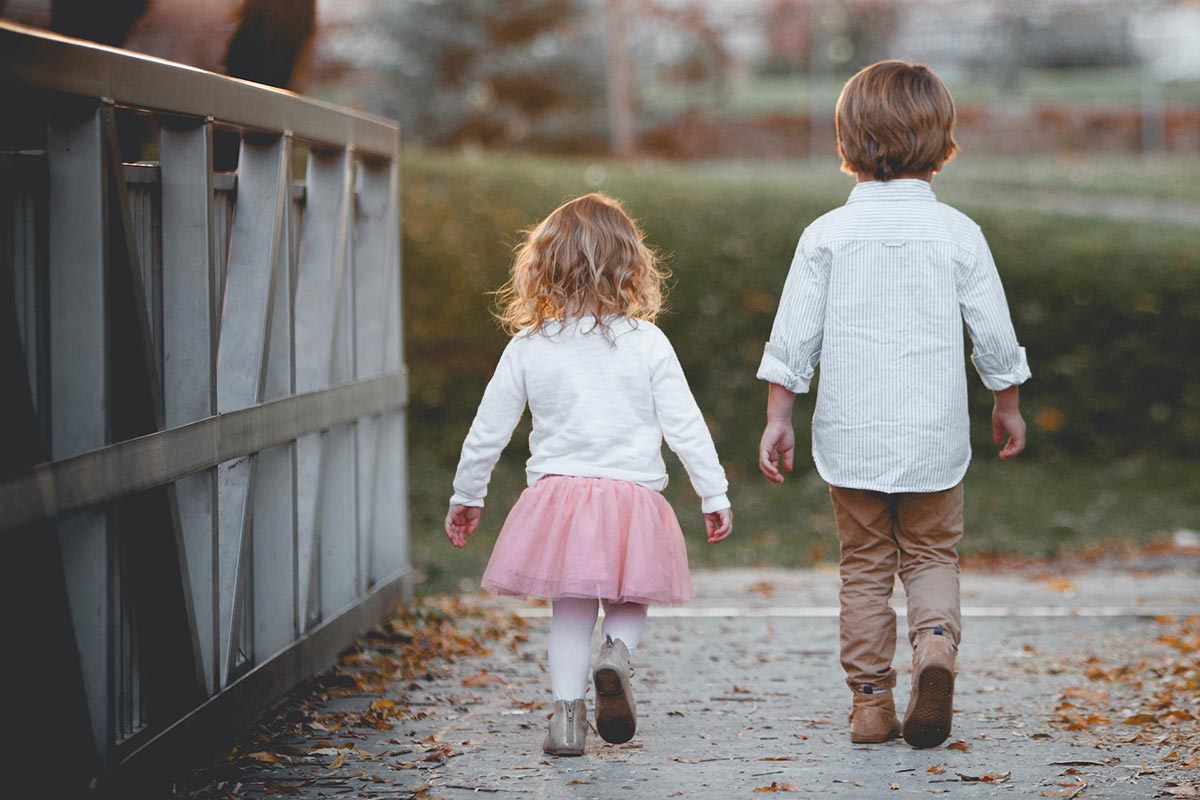 little girl boy back walking